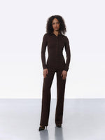 Woman wearing classic brown tailored jumpsuit with straight-leg cut